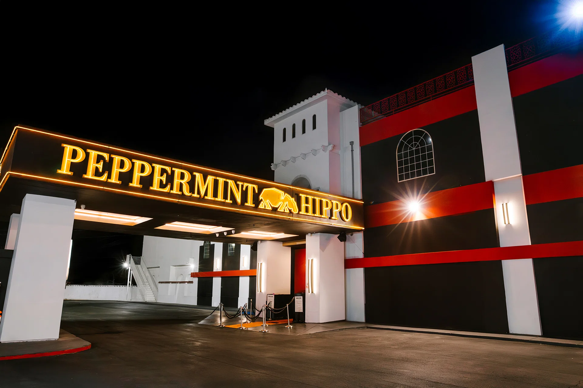 Peppermint Hippo entrance with illuminated club sign